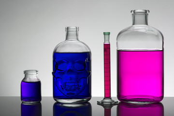 Liquid in laboratory bottles. Scientific biochemical laboratory. Colorful liquid.