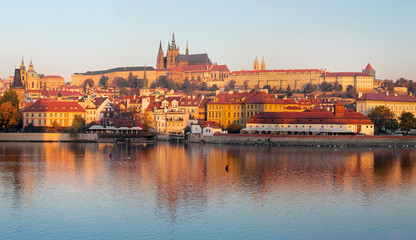 Prague - The Mala Strana, Castle and Cathedral from promenade over the  Vltava river in the morning light.