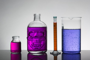 Liquid in laboratory bottles. Scientific biochemical laboratory. Colorful liquid.