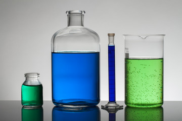 Liquid in laboratory bottles. Scientific biochemical laboratory. Colorful liquid.