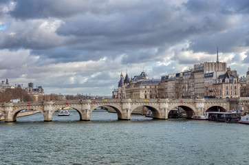 Fototapeta premium Panorama of Ile de la Cite, the Conciergerie and Pont Neuf on a cloudy day in winter - Paris, France