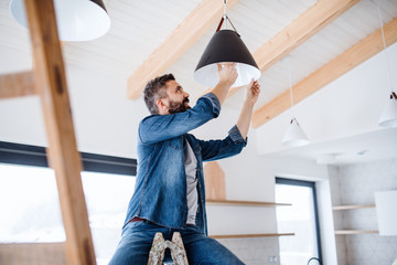 A mature man furnishing new house, a new home concept.