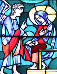 Fototapeta na wymiar The Annunciation, Stained glass window in Basilica of St. Vitus in Ellwangen, Germany