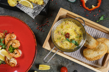Beer mug, grilled shrimps, sausages and pretzel on wooden table. Top view