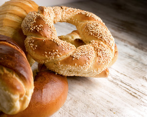 Freshly baked crispy pretzel with sesame on rustic table