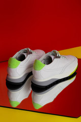 Sport shoes studio shooting on mirror