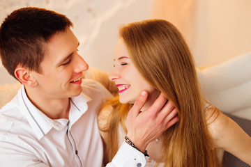 Close-up of a guy holding a hand near the face of a girl who clo