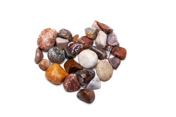 A heart shape made with pebbles on white
