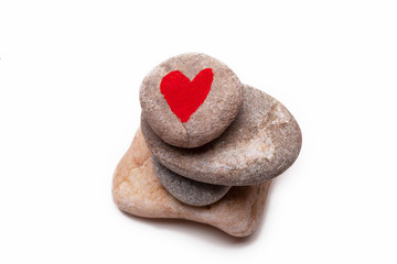 Obraz premium A pile of pebbles with a heart shape painted on the top one
