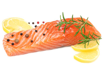 Red fish. Raw salmon fillet with rosemary and lemon isolate on white background.