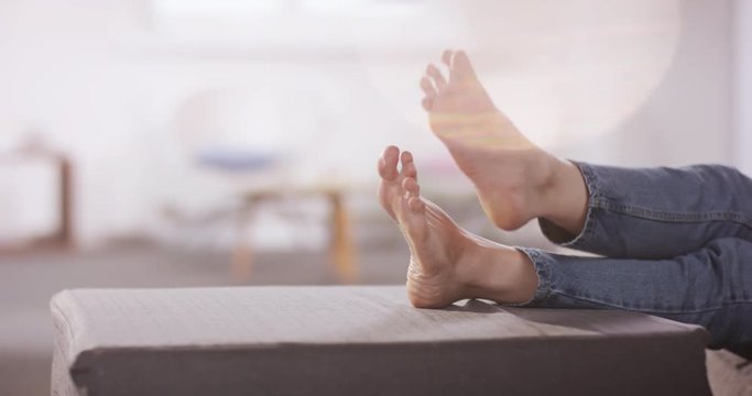 Close-up of caucasian woman putting up her small feet