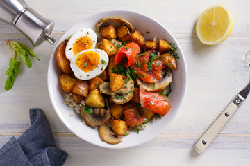 Healthy food bowl: salmon, eggs, potatoes, mushrooms, rice and spinach on white wooden table. overhead, horizontal