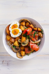 Healthy food bowl: salmon, eggs, potatoes, mushrooms, rice and spinach on white wooden table. overhead, vertical