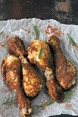 Roasted chicken legs on paper. Grilled chicken legs.