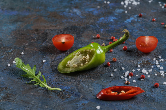 Selection of spices herbs and greens. Ingredients for cooking. Food background on blue nable. Top view copy space.