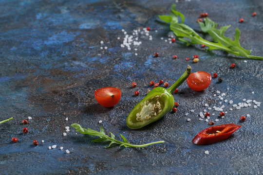 Selection of spices herbs and greens. Ingredients for cooking. Food background on blue nable. Top view copy space.