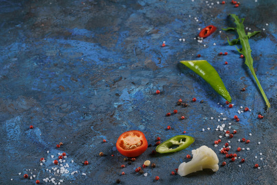 Selection of spices herbs and greens. Ingredients for cooking. Food background on blue nable. Top view copy space.