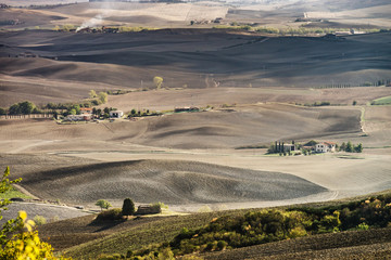 Obraz premium Autumn in Italy. Yellow plowed hills of Tuscany with interesting shadows and lines