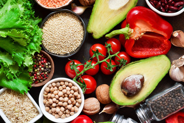 Fresh, raw vegetables on the kitchen table. Health food, clean food, choice: fruits, vegetables, seeds, superfoods, cereals, leafy vegetables. Ingredients for cooking. Top view.