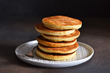 Homemade, hot pancakes on the kitchen table. Traditional American dessert.