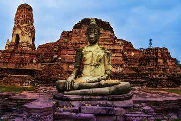Ancient statue of sitting Buddha in Wat Mahathat temple. Ayutthaya historical park, Thailand. Artistic photo, toned.