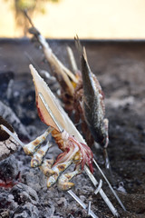 Grilled seafood on a coal hearth.