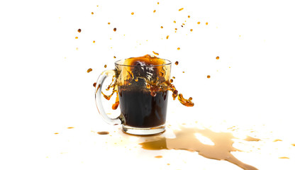A cup of coffee with splashes in the process of spilling