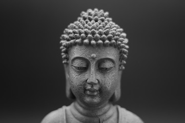 Fototapeta na wymiar Buddha statue on black dark background