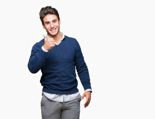 Fototapeta premium Young handsome business man over isolated background doing happy thumbs up gesture with hand. Approving expression looking at the camera with showing success.