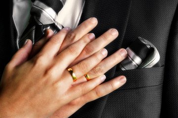 bride and groom hands with gold rings, newlyweds wedding  background