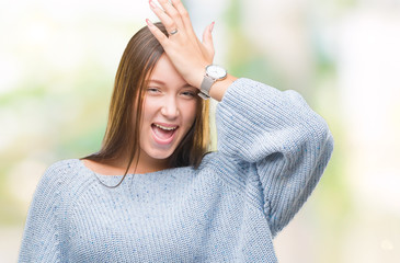 Young beautiful caucasian woman wearing winter sweater over isolated background surprised with hand...