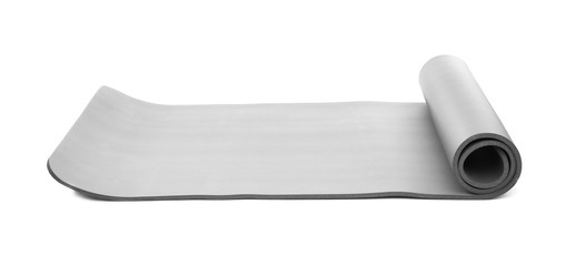 Rolled grey yoga mat on white background