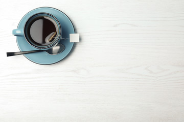 Cup of hot fresh tea on wooden background, top view. Space for text