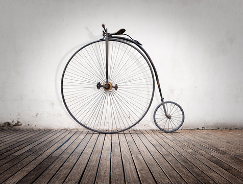 Fototapeta penny-farthing, high  wheel retro bike  on wood floor