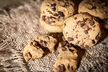 Fresh Chocolate chip cookies, freshly baked on rustic background. Close-up view with selective focus.