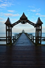Obraz premium Blick durch einen Holzbogen zur Tauchgondel auf der Seebrücke in Sellin, auf Rügen in Deutschland