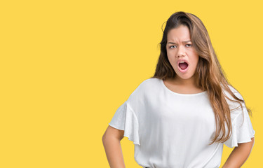 Obraz premium Young beautiful brunette business woman over isolated background In shock face, looking skeptical and sarcastic, surprised with open mouth