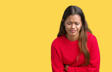 Young beautiful brunette woman wearing red winter sweater over isolated background with hand on stomach because nausea, painful disease feeling unwell. Ache concept.