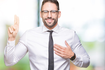 Young handsome business man wearing glasses over isolated background Swearing with hand on chest and fingers, making a loyalty promise oath