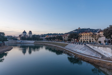 Fototapeta na wymiar Evening view of the Adige river from the Pietra bridge in Verona