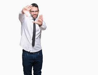 Young handsome business man wearing glasses over isolated background Smiling doing frame using hands palms and fingers, camera perspective