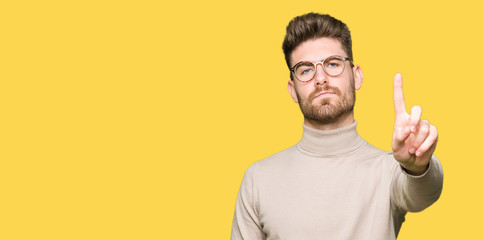 Fototapeta premium Young handsome business man wearing glasses Pointing with finger up and angry expression