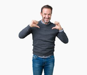 Fototapeta premium Handsome middle age senior man wearing a sweater over isolated background looking confident with smile on face, pointing oneself with fingers proud and happy.