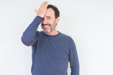 Handsome senior man over isolated background surprised with hand on head for mistake, remember...