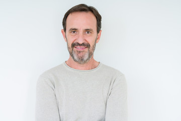 Fototapeta premium Elegant senior man over isolated background with serious expression on face. Simple and natural looking at the camera.