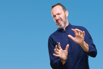 Middle age hoary senior man over isolated background disgusted expression, displeased and fearful...