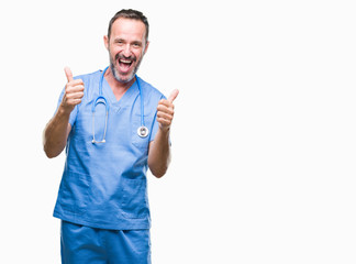 Middle age hoary senior doctor man wearing medical uniform over isolated background success sign doing positive gesture with hand, thumbs up smiling and happy. Looking at the camera