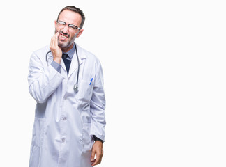 Middle age senior hoary doctor man wearing medical uniform isolated background touching mouth with hand with painful expression because of toothache or dental illness on teeth. Dentist concept.