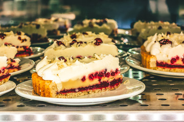 Pie with cranberries and cream laid out for sale in a cafe