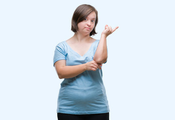 Young adult woman with down syndrome over isolated background with a big smile on face, pointing with hand and finger to the side looking at the camera.
